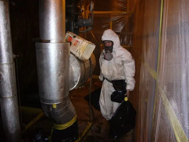 Asbestos abatement employee wearing PPE